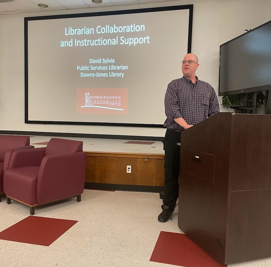 Photo of librarian David Sylvia giving a presentation entitled "Librarian Collaboration and Instructional Support".
