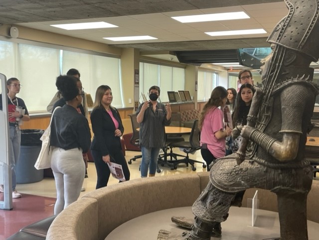 Photo of a library tour near the Oba statue, downstairs in the library.