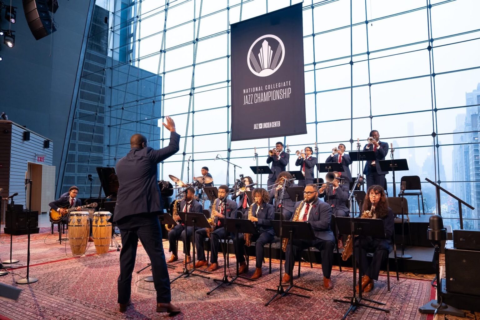 Huston–Tillotson University’s student jazz orchestra performs at Jazz at Lincoln Center as its director conducts beneath the National Collegiate Jazz Championship banner